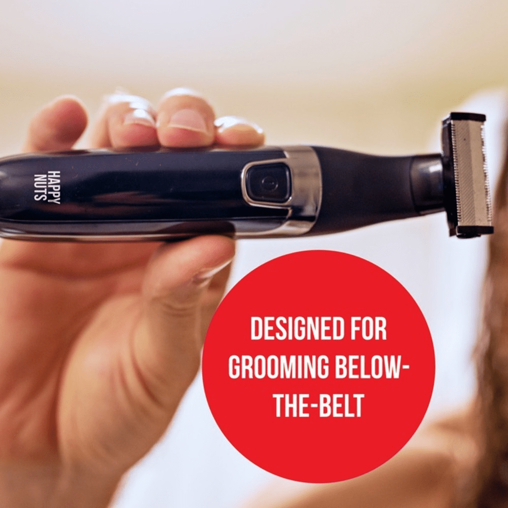 Hand holding Happy Nuts Ballber male grooming tool with text that reads "designed for grooming below the belt"