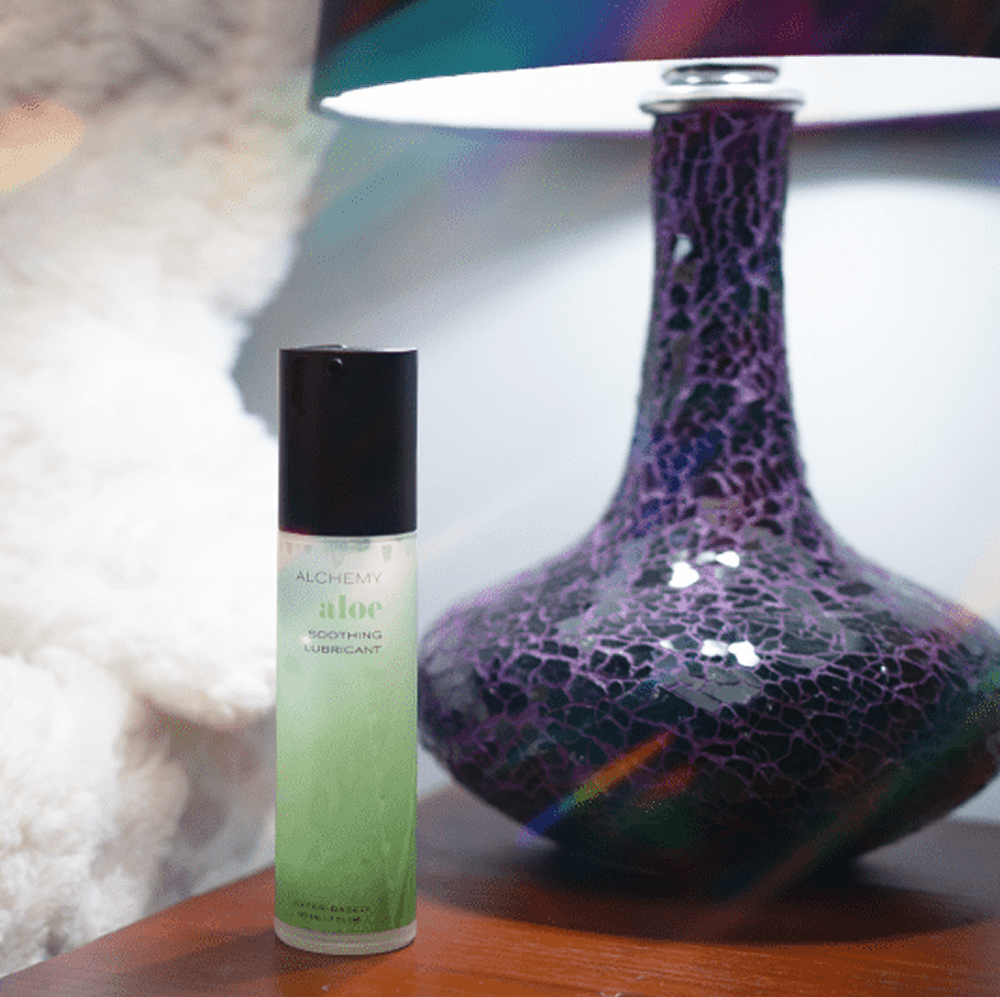 Alchemy Aloe: Hydrating Water-Based Personal Lubricant bottle on nightstand