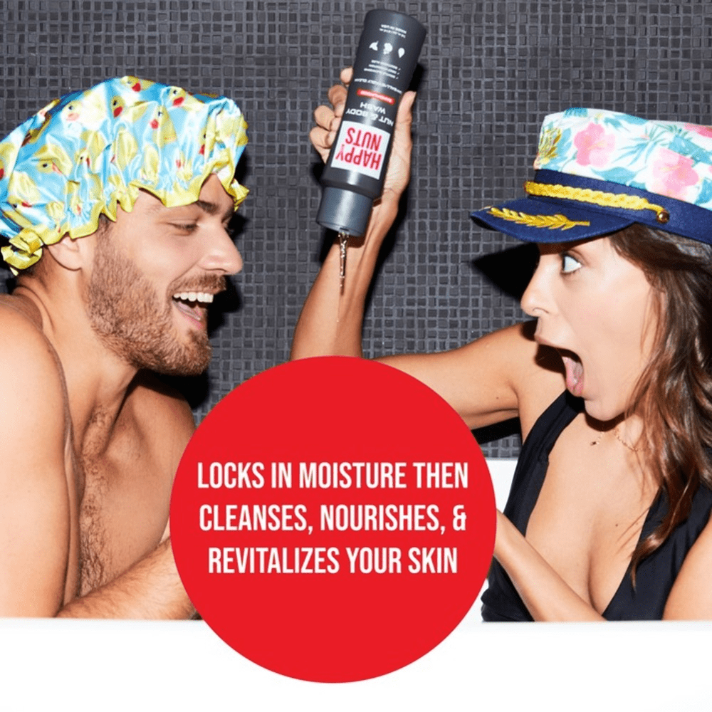 Two people wearing colorful shower caps with a bottle of Happy Nuts Nut & Body Wash between them, against a tiled wall background