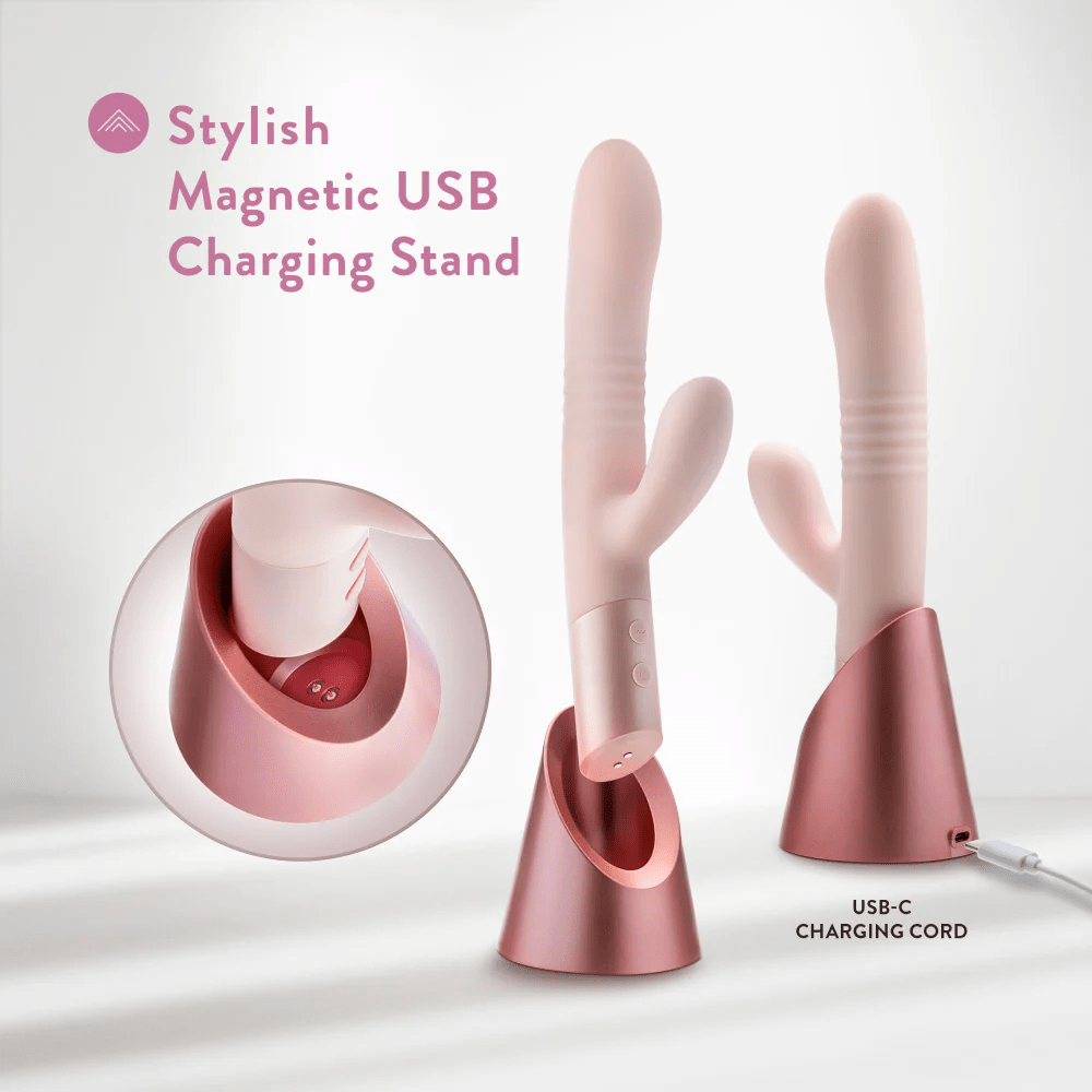 Blush Fraya Thrusting G-Spot Clitoral Rabbit Vibrator photo of product with magnetic USB-C charging stand on a light pink background