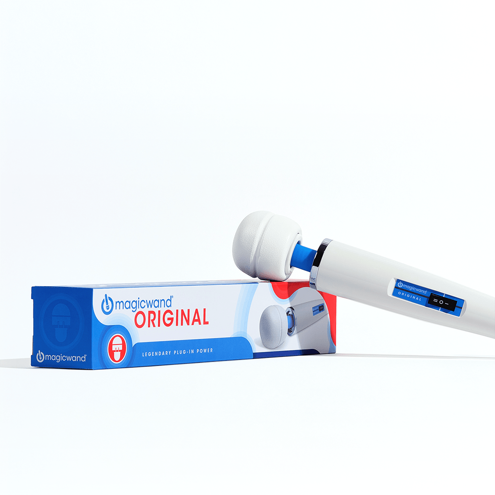 Photo of the Hitachi Magic Wand Original HV-260 plug-in wand massager resting on its packaging on a white surface with bright overhead studio lighting