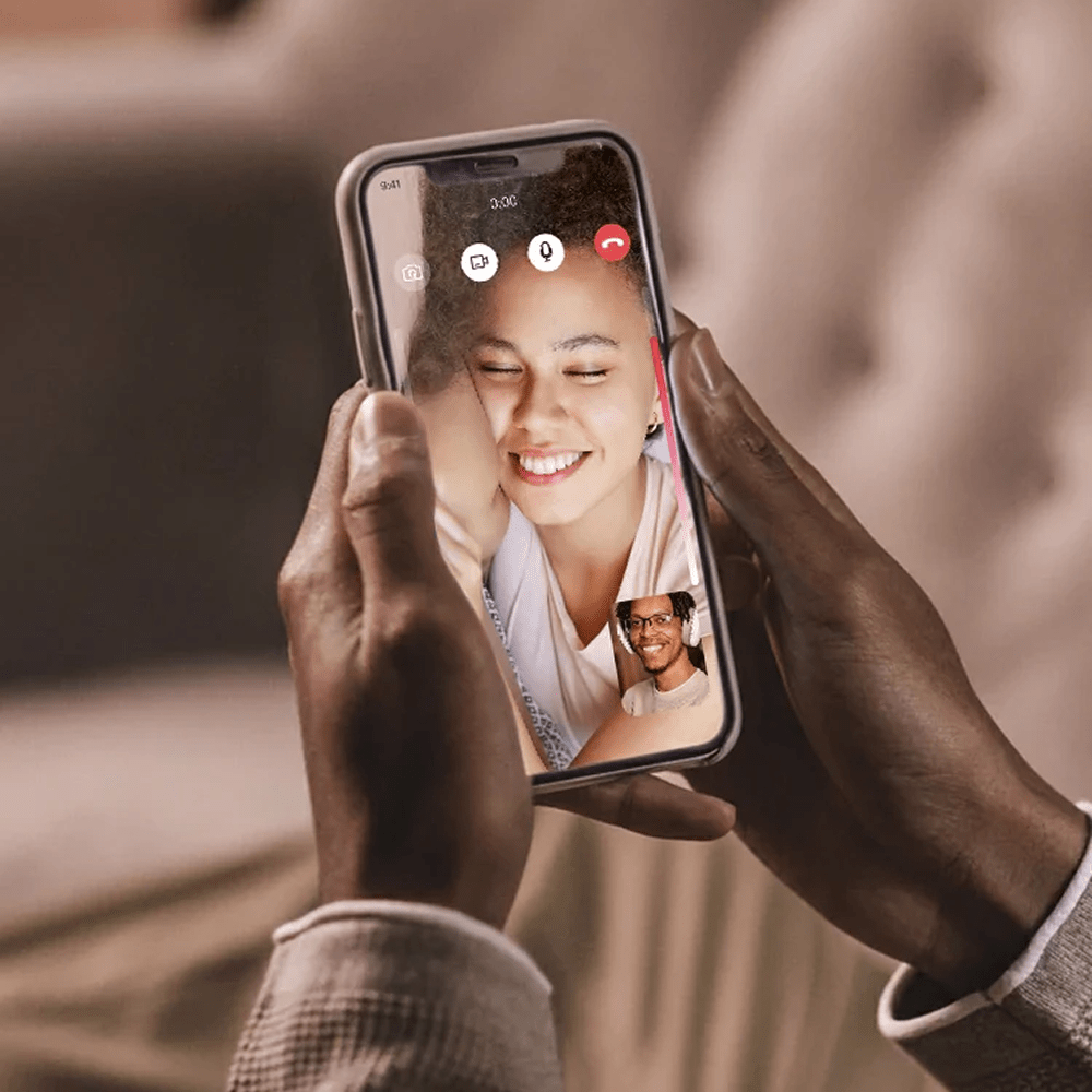 Two people on a video call via a smartphone with a blurred background