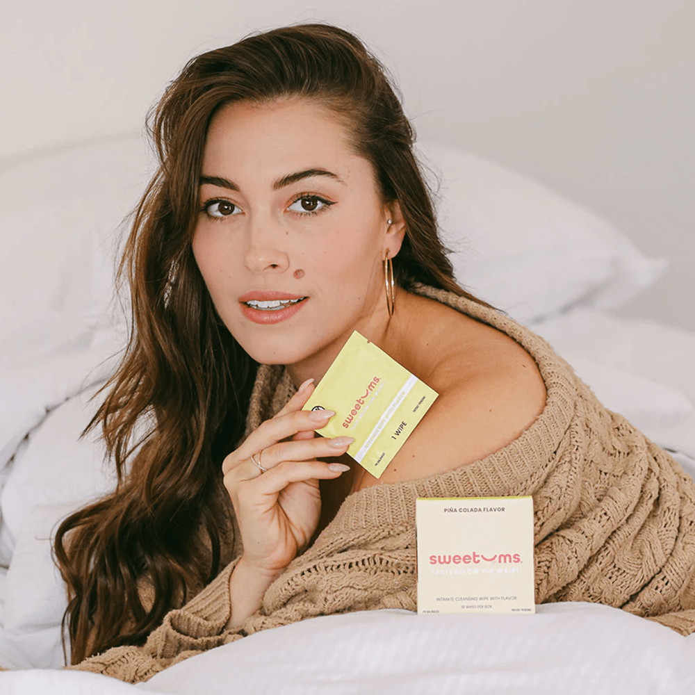Woman with a box of Sweetums intimate wipes