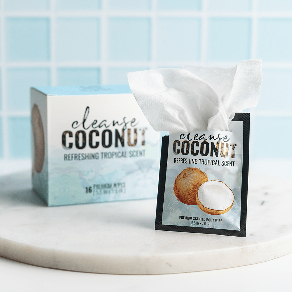 Alchemy Cleanse Coconut-Scented intimate wipes on a marble slab with a tile background and bright, even lighting