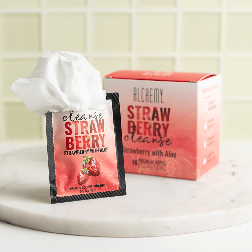 Alchemy Cleanse Strawberry Scented Wipes on marble surface with box and pink tile background