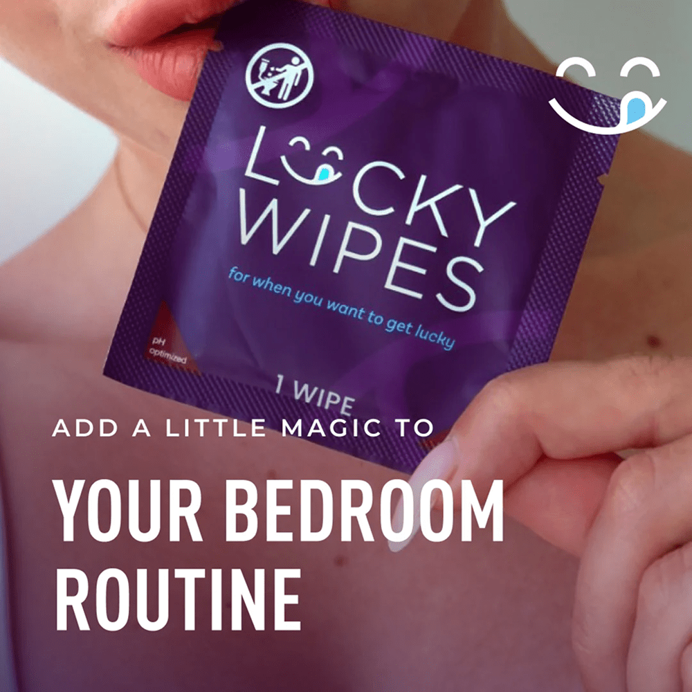 Purple packet of Sweetums Lucky Wipes held by a person with white text that says "add a little magic to your bedroom"