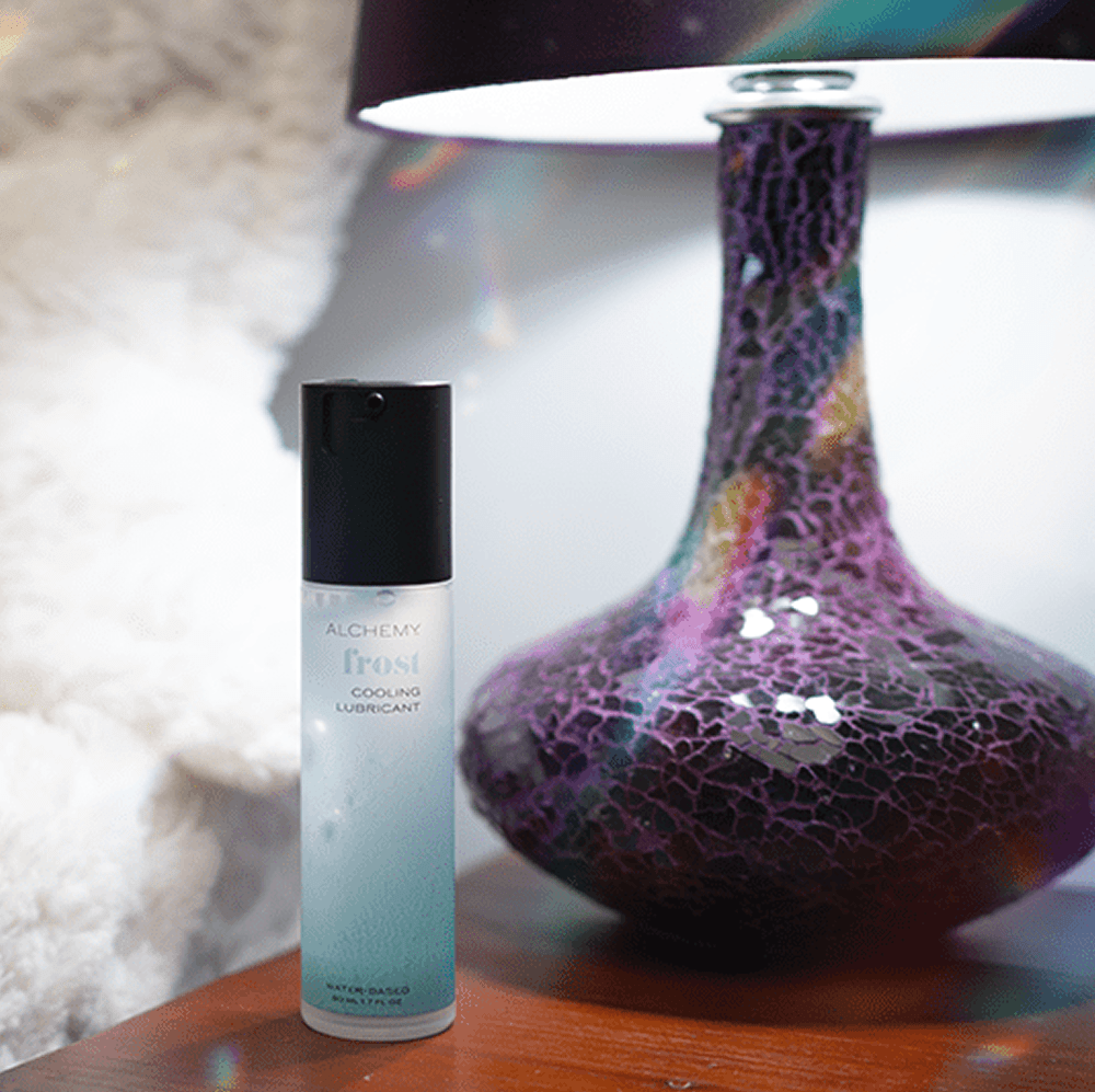 Alchemy Frost: Water-Based Cooling Personal Lubricant bottle on nightstand