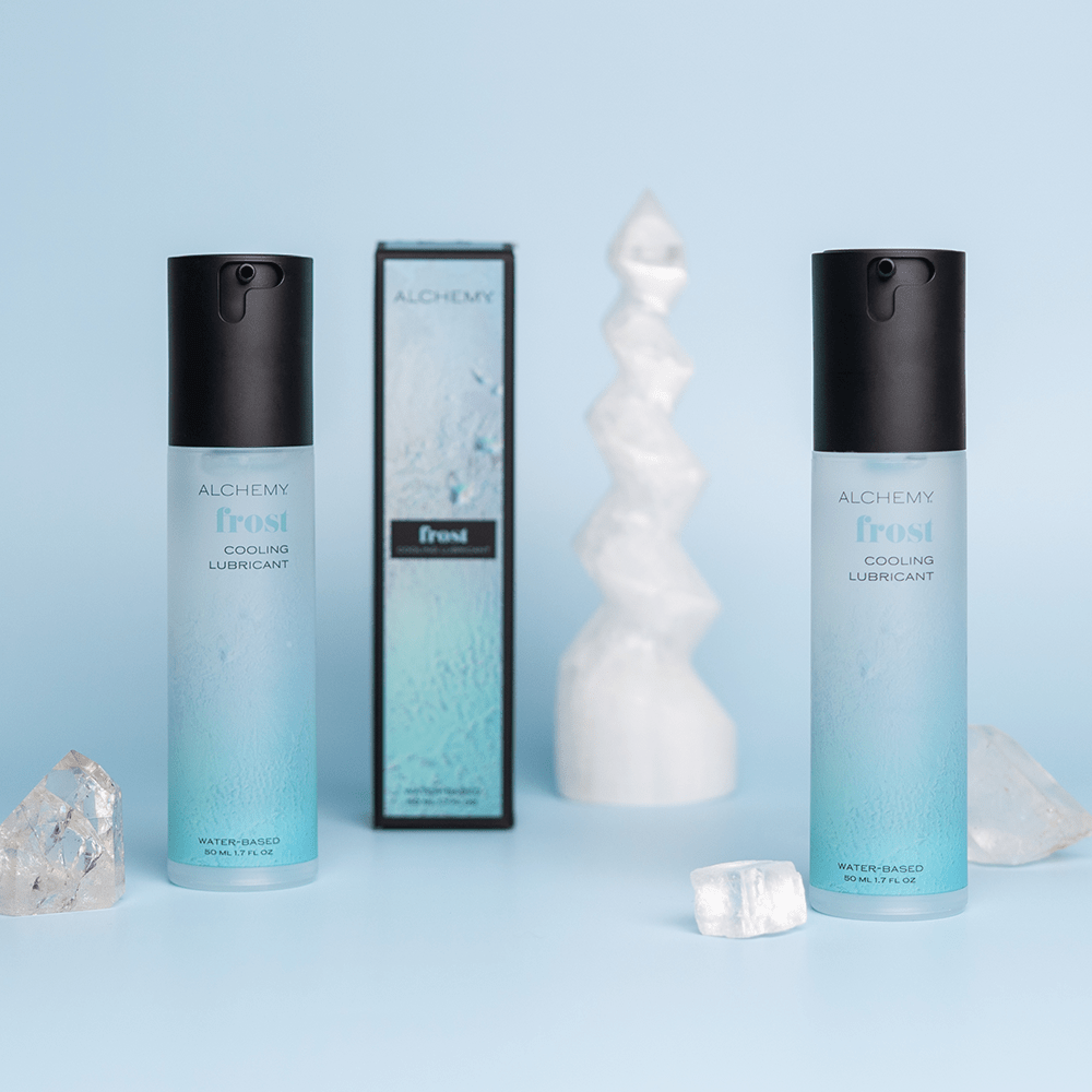 Alchemy Frost: Water-Based Cooling Personal Lubricant with box on blue background with crystals