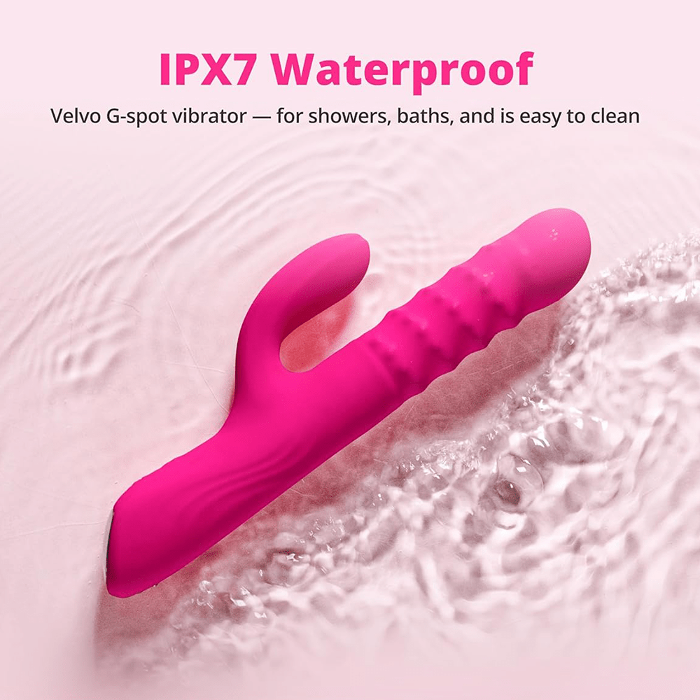 Lovense Velvo app-controlled thrusting rabbit vibrator in water on a gray background highlighting IPX7 waterproof features allowing the product to be used in showers, baths, and easy cleaning