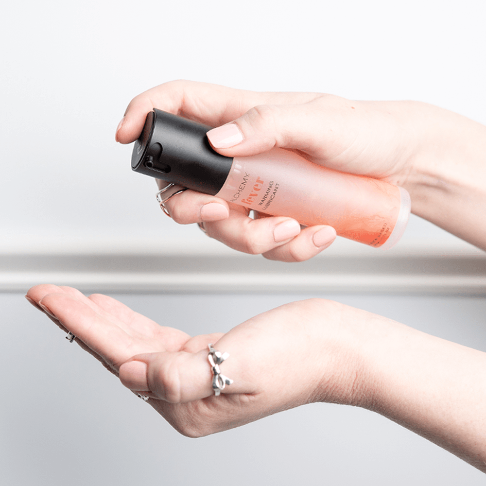 Alchemy Frost: Water-Based Cooling Personal Lubricant bottle in woman's hand