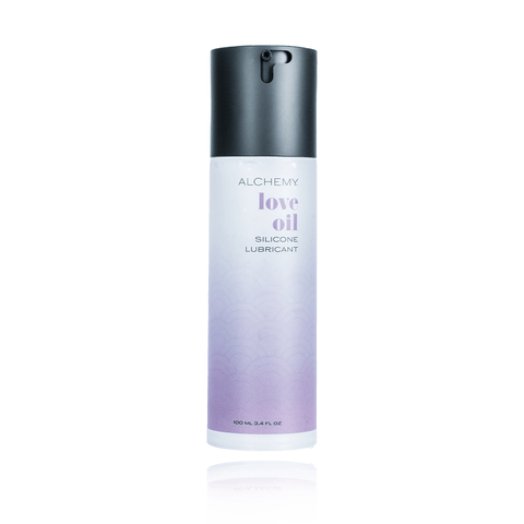 Alchemy Love Oil Silicone Personal Lubricant on a white background with reflection