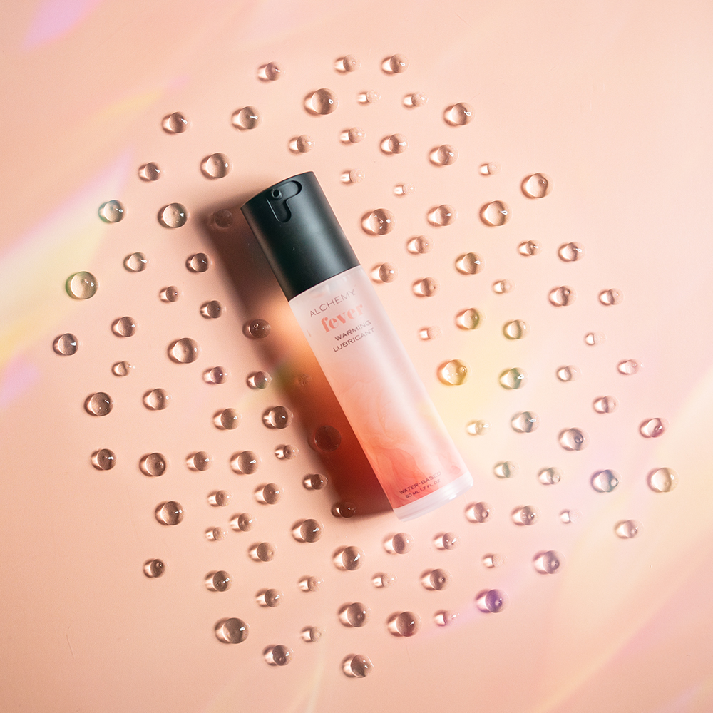 Alchemy Warming Personal Lubricant bottle with liquid droplets