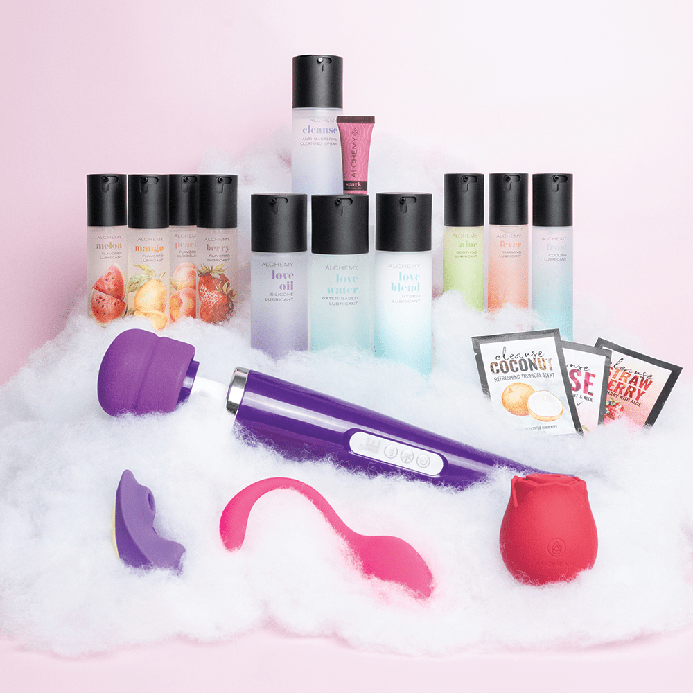 Amazing Intimate Essentials Alchemy Discovery Kit on a fluffy cloud texture against a pink background