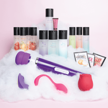 Amazing Intimate Essentials Alchemy Discovery Kit on a fluffy cloud texture against a pink background