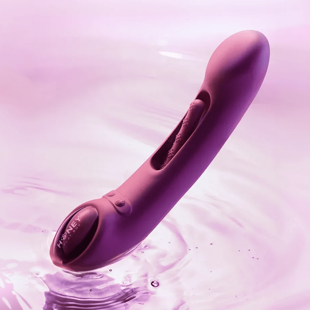 Honey Play Box Tempo App-Controlled Tapping Vibrator - photo with studio lighting touching the surface of water with a brightly-lit background