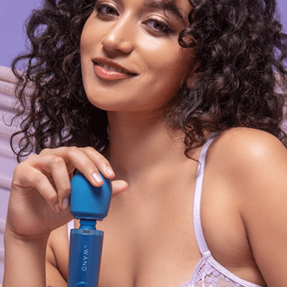 Photo of a woman holding blue Le Wand Petite Wand Vibrator