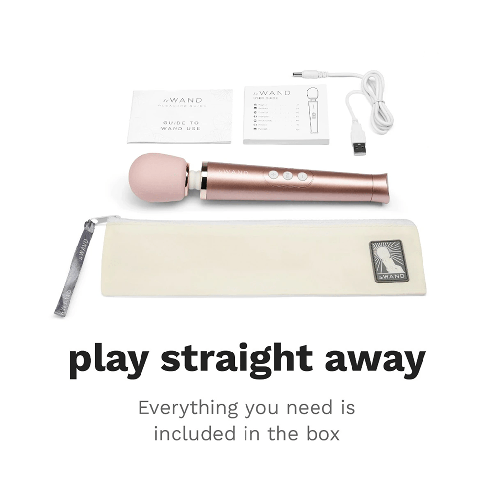 Photo of rose gold Le Wand Petite Luxury Wand Massager on a white background with dark gray text and included accessories: "Play Straight Away: everything you need is included in the box"