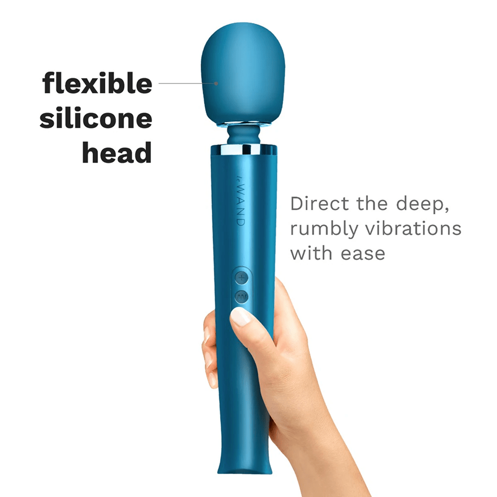 Photo of blue Le Wand Rechargeable Luxury Wand Massager in a woman's hand on a white background with dark gray text: "Flexible silicone head: direct the deep, rumbly vibrations with ease