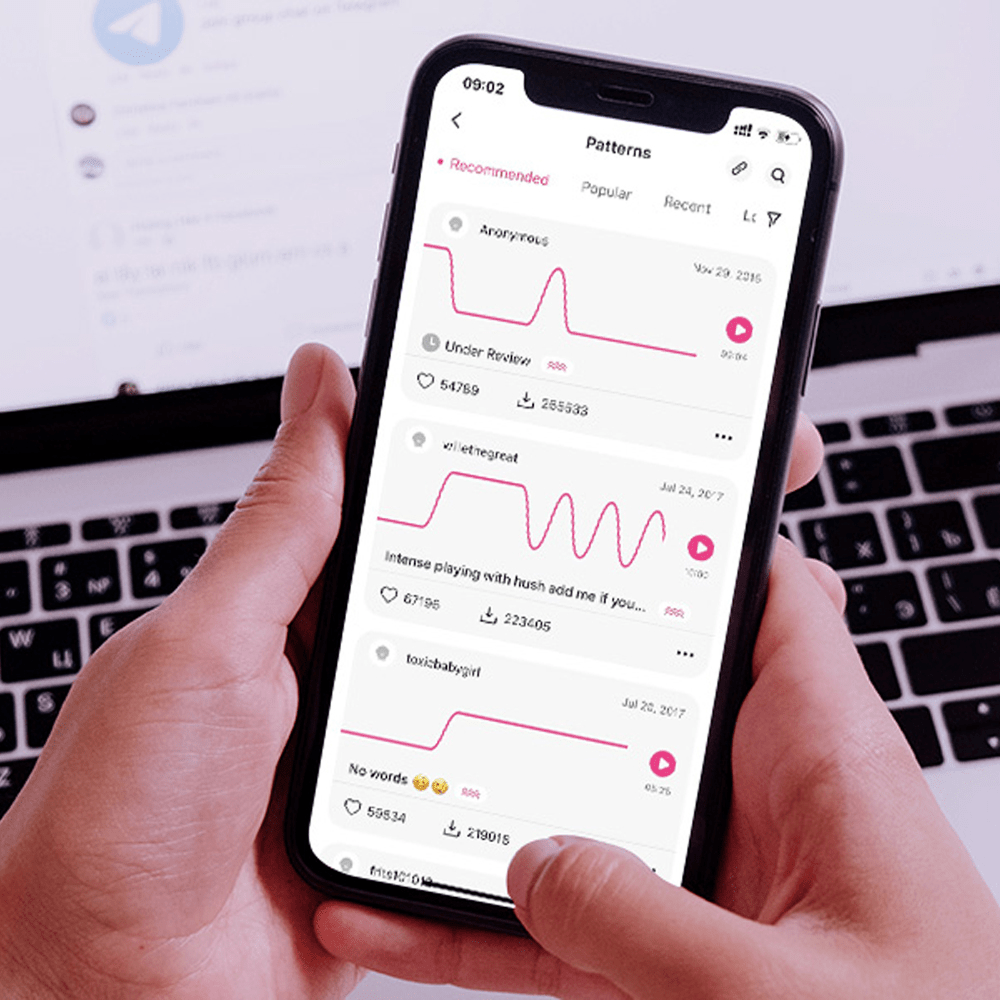 Photo of person's hand holding smartphone with Lovense app screen showing custom vibration pattern functionality