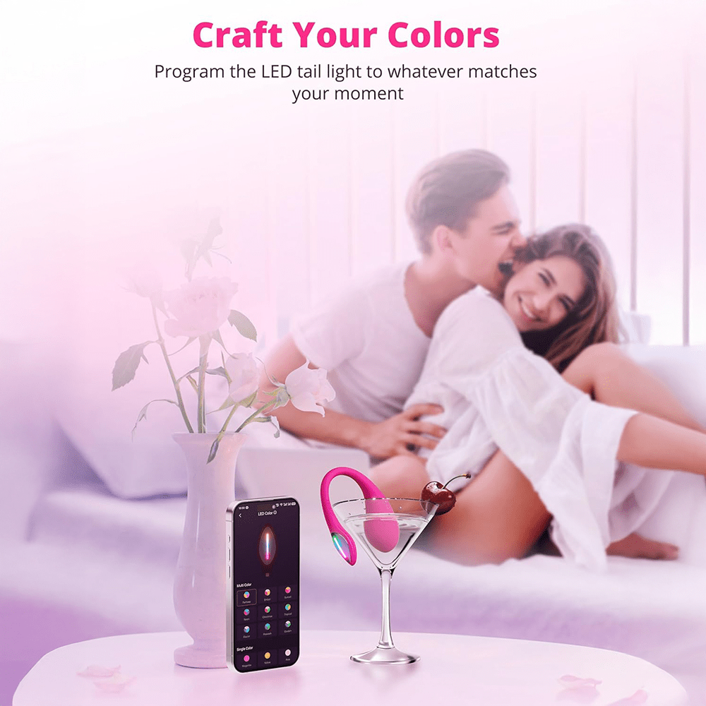 Photo of a couple in bed with a smartphone and Lovense Lush Mini App-Controlled Egg G-Spot Vibrator in a martini glass with text that says "Craft Your Colors: Program the LED tail light to whatever matches your moment"