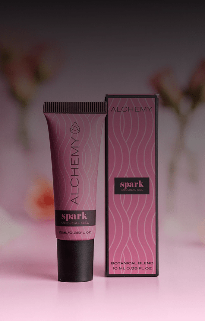 Alchemy Spark Female Arousal Gel product packaging on a pink background