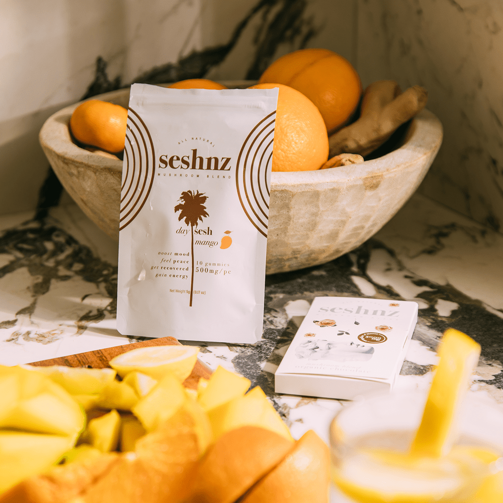 Seshnz Day Sesh functional mushroom gummies product packaging on a marble surface with fruits in the background