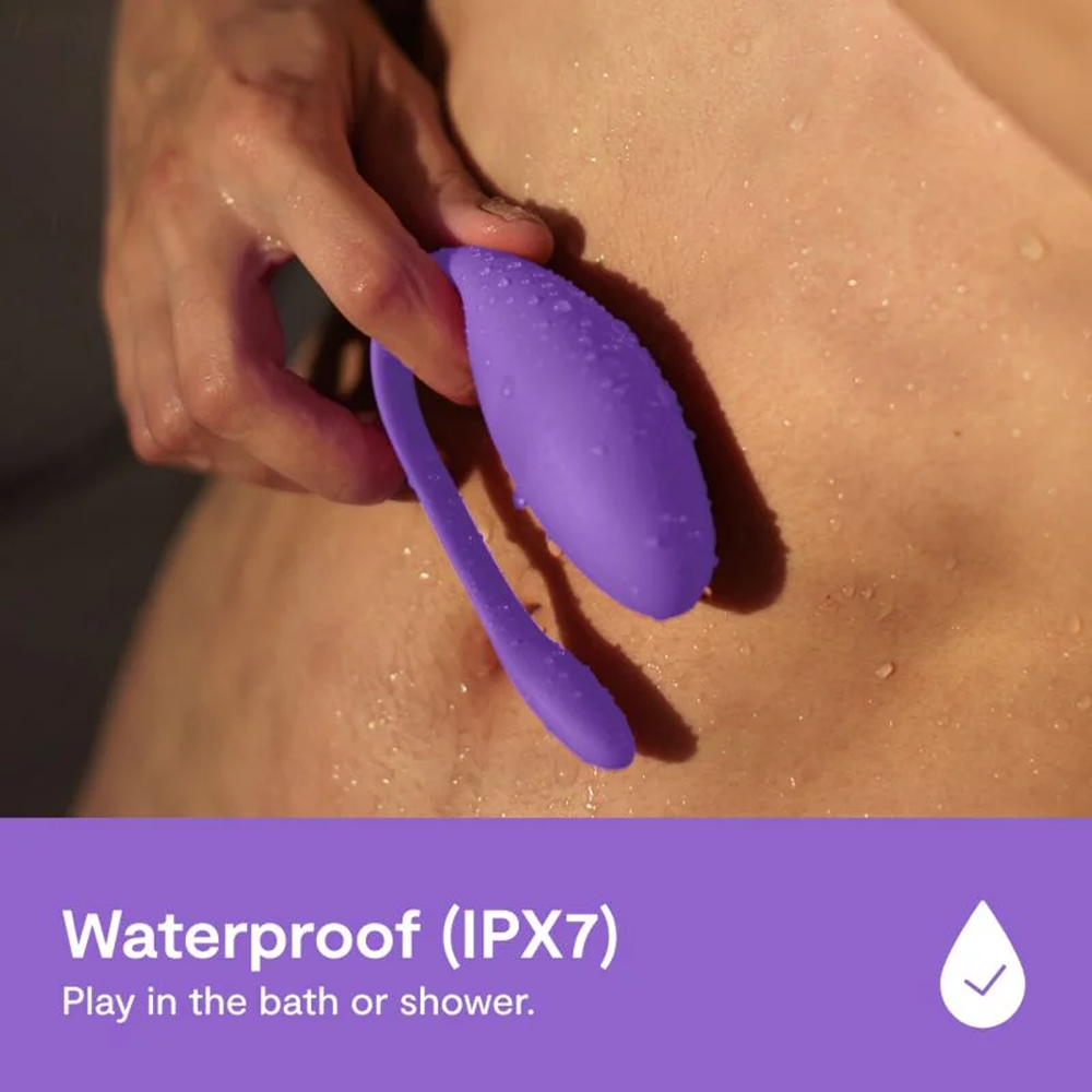 We-Vibe Jive Lite: Waterproof (IPX7), play in the bath of shower. Photo of a woman's hand holding product against her skin with water droplets with a blue bar and white text at the bottom.